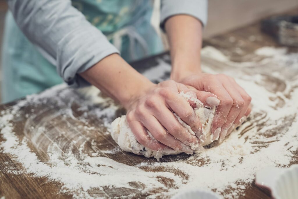 a woman making toll house cookie recipe