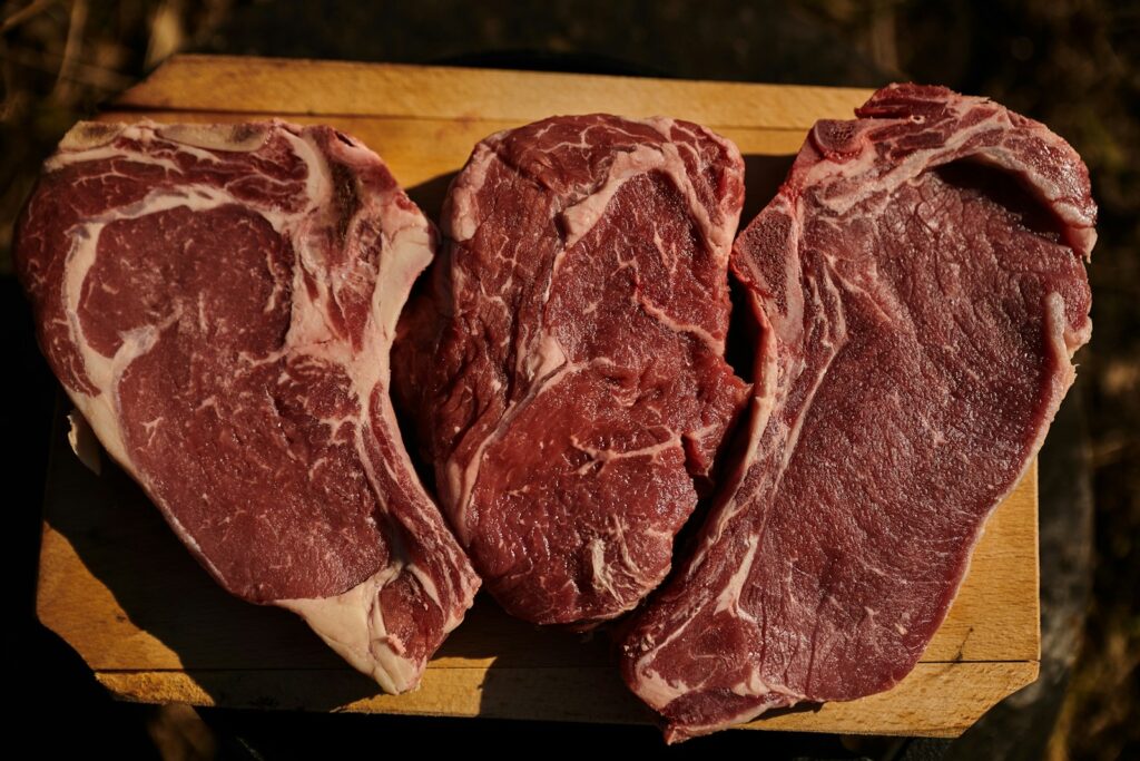 two pieces of steak on a cutting board used to answer the question: What Can I Use a Chuck Roast For?