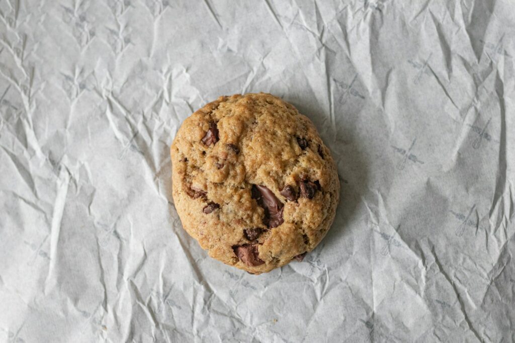 brown cookie on white textile to explain toll house cookie recipe